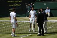 Serbia's Novak Djokovic and Great Britain's Andy Murray watch as the coin toss is performed before their Men's Singles Final during day thirteen of the Wimbledon Championships at The All England Lawn Tennis and Croquet Club, Wimbledon.