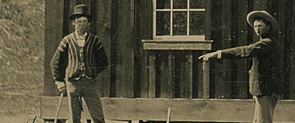 Billy the Kid holds croquet mallet on the left in this antique tintype photograph