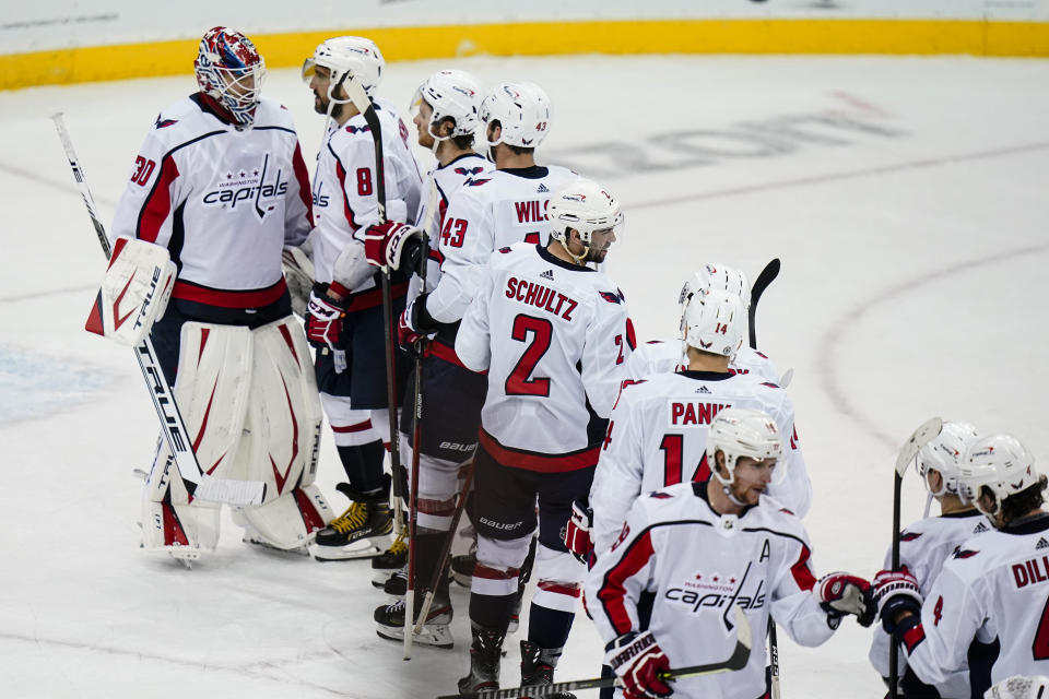 Washington Capitals' Ilya Samsonov (30) and Alex Ovechkin (8) celebrate with teammates after an NHL hockey game against the New Jersey Devils on Sunday, April 4, 2021, in Newark, N.J. The Capitals won 5-4. (AP Photo/Frank Franklin II)