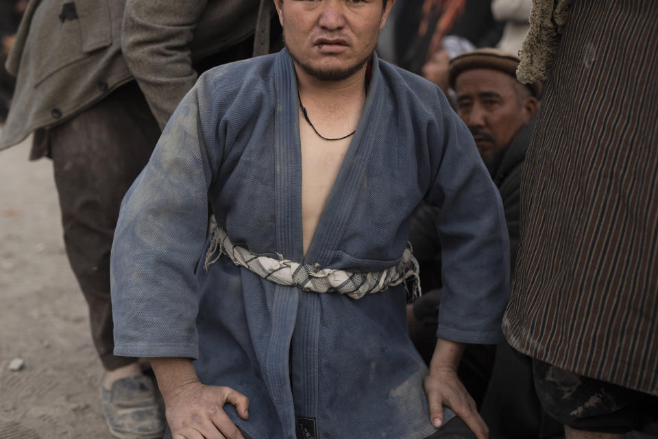 An Afghan men prepares to compete a wrestling match in Kabul, Afghanistan, Friday, Dec. 3 , 2021. The scene is one played out each week after Friday prayers in the sprawling Chaman-e-Huzori park in downtown Kabul, where men, mainly from Afghanistan's northern provinces, gather to watch and to compete in pahlawani, a traditional form of wrestling. (AP Photo/ Petros Giannakouris)