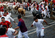 <p>Runners sprint ahead of bulls during the first running of the bulls at the San Fermin festival in Pamplona, northern Spain, July 7, 2017. (Susana Vera/Reuters) </p>