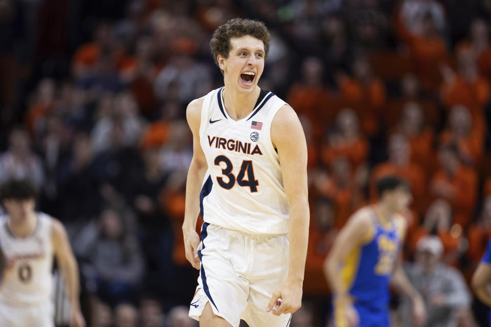 Virginia's Jake Groves (34) celebrates during the first half of the team's NCAA college basketball game against Pittsburgh on Tuesday, Feb. 13, 2024, in Charlottesville, Va. (AP Photo/Mike Kropf)
