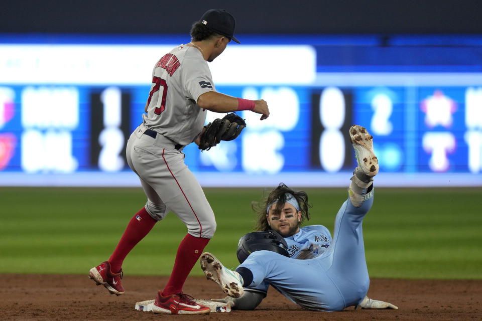 Boston Red Sox shortstop David Hamilton tags out Toronto Blue Jays shortstop Bo Bichette at second base on a double during the third inning of a baseball game in Toronto, Sunday, July 2, 2023. (Frank Gunn/The Canadian Press via AP)