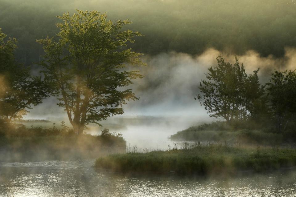 Fog rises from the Penobscot River's East Branch in the Katahdin Woods and Waters National Monument near Patten, Maine, on Aug. 10, 2017.