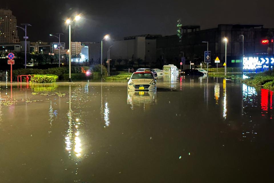 Vehicles are stranded on a flooded street following heavy rains in Dubai early on April 17, 2024.