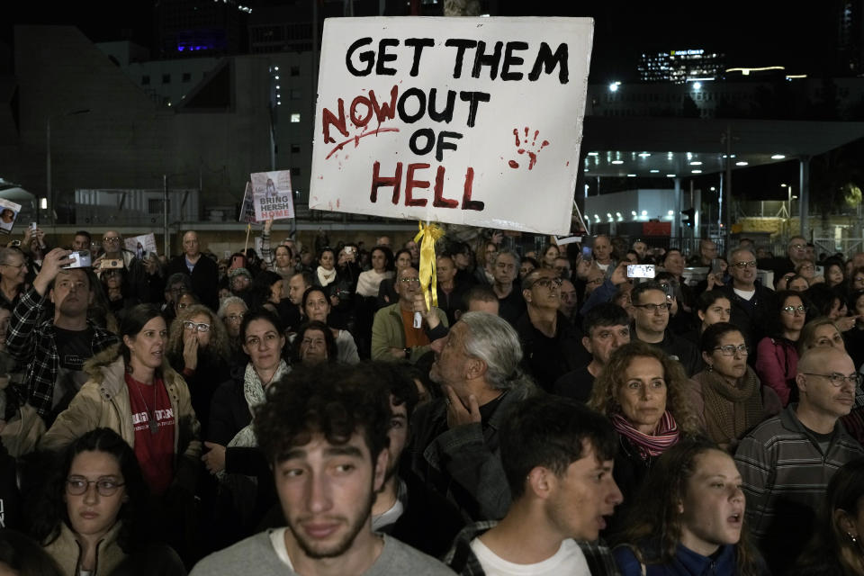 A man holds a sign calling for the release of the hostages taken by Hamas militants to Gaza during the Oct. 7th attack, during a demonstration in Tel Aviv, Israel, Saturday Jan. 20, 2024. (AP Photo/Leo Correa)