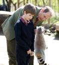 <p>Edward with his son James fed lemurs during a visit to the Wild Place Project at Bristol Zoo. So cute!</p>