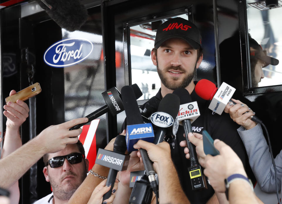 Daniel Suarez talks to the media before practice for a NASCAR Cup Series auto race on Friday, Nov. 15, 2019, at Homestead-Miami Speedway in Homestead, Fla. Suarez has been fired for the second time in a year, this time by Stewart-Haas Racing as it makes room to promote Cole Custer to the Cup Series in 2020. (AP Photo/Terry Renna)