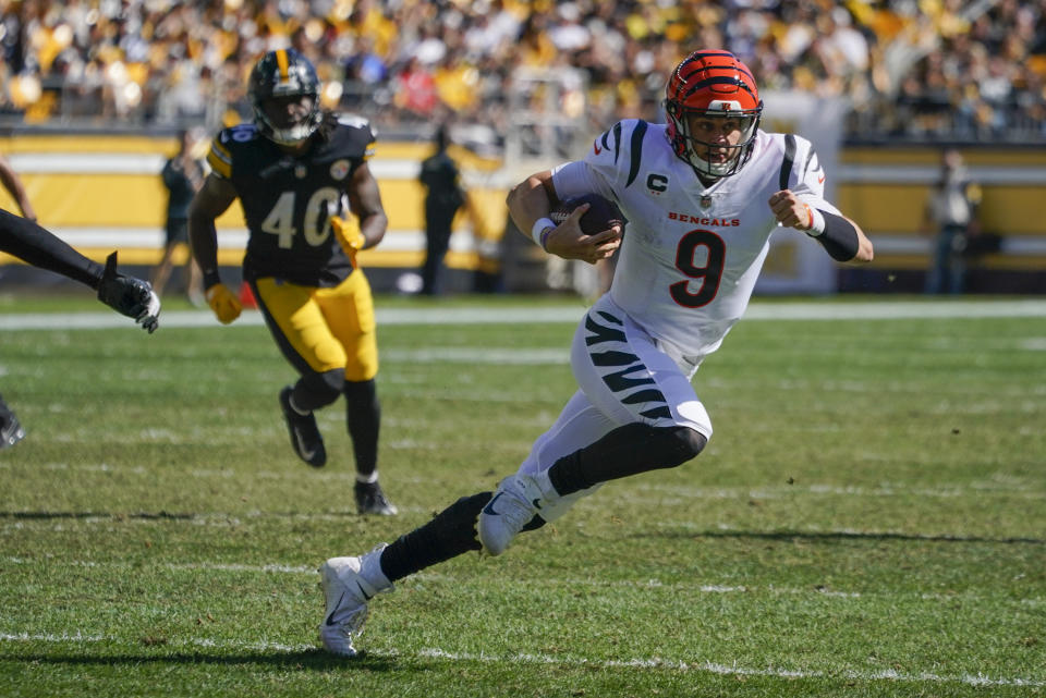 Cincinnati Bengals quarterback Joe Burrow (9) scrambles for a first down against the Pittsburgh Steelers during the second half an NFL football game, Sunday, Sept. 26, 2021, in Pittsburgh. (AP Photo/Gene J. Puskar)