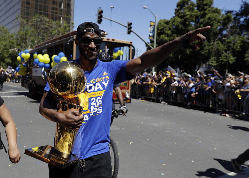 Ian Clark holds the Larry O’Brien Trophy during the Warriors’ title parade. (AP)