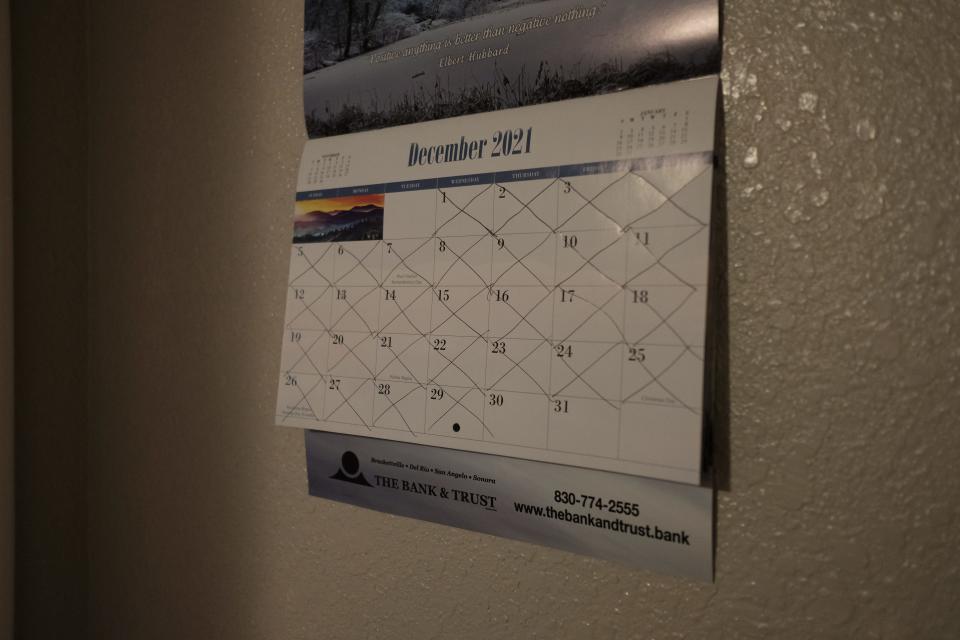 A calendar on a wall with days crossed off.