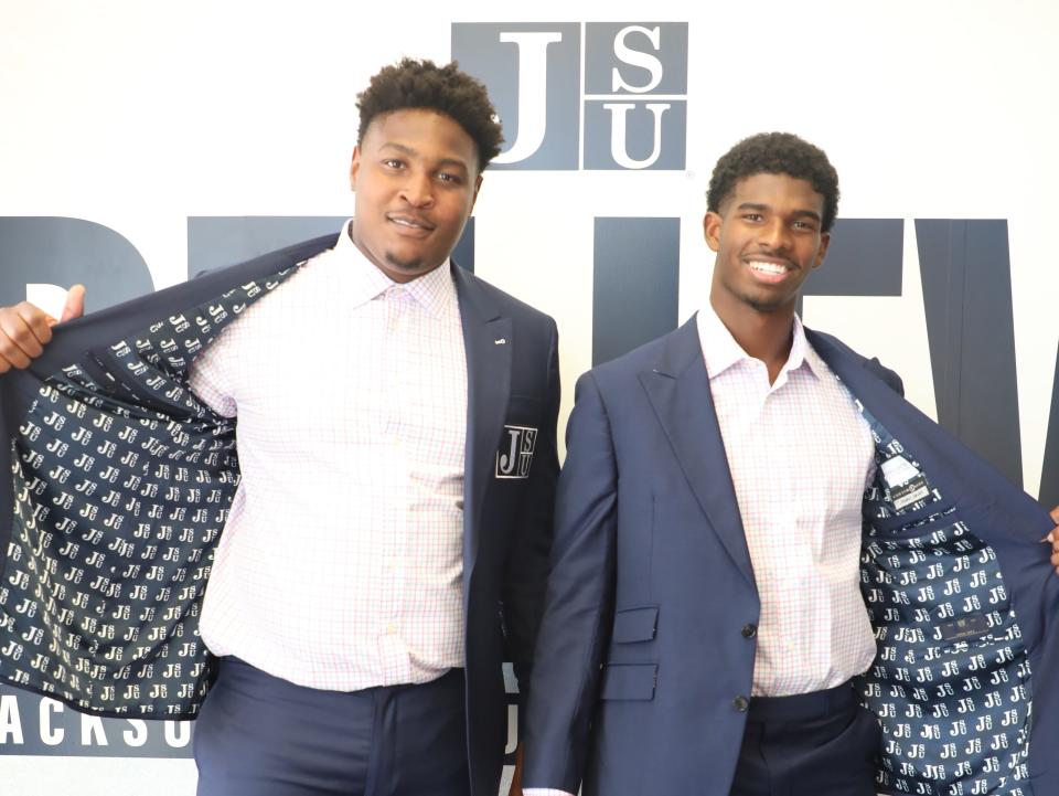 Two Jackson State players show off their new suits.