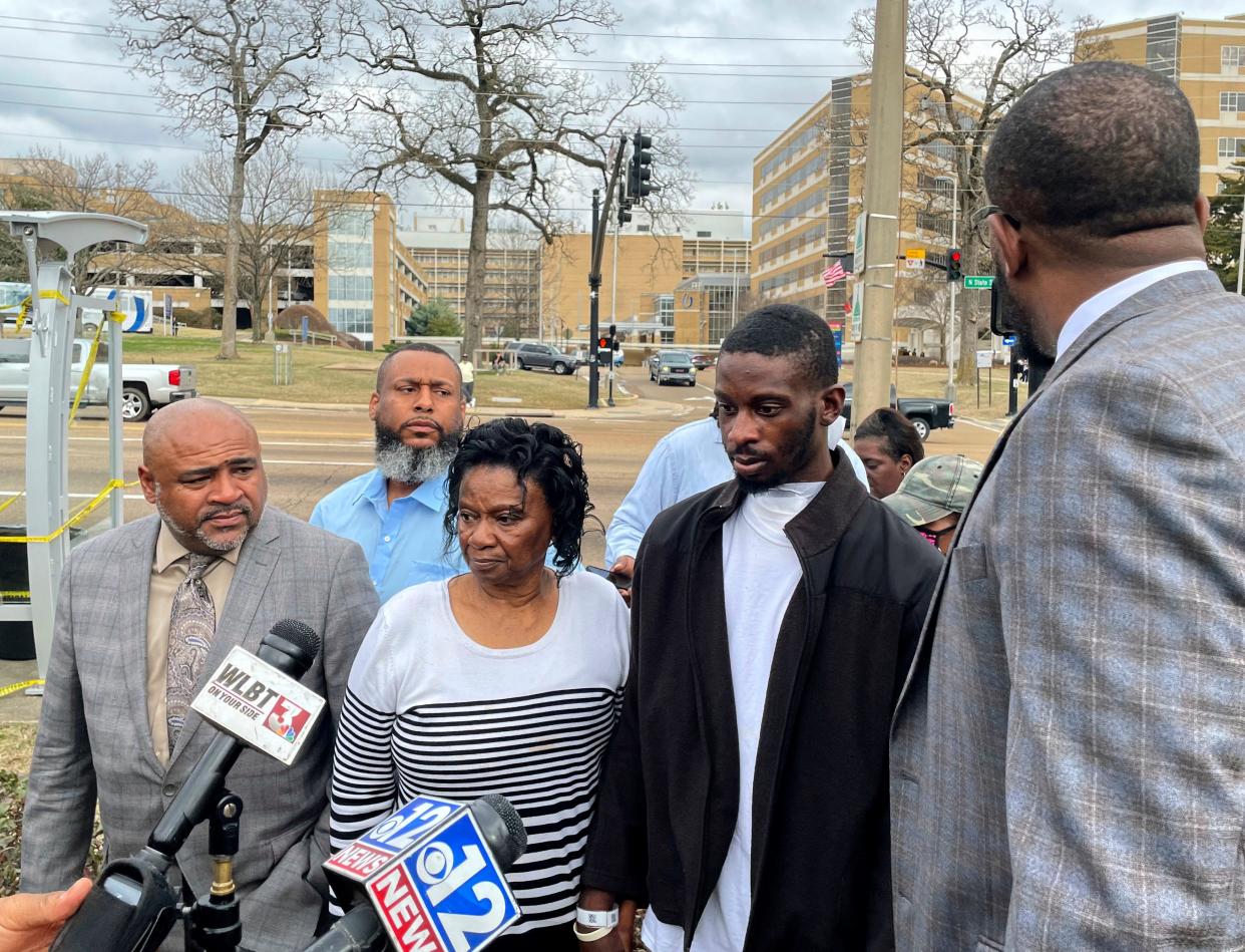 Michael Jenkins, second from right, stand with his mother, Mary Jenkins, center, and their attorneys at a news conference Wednesday, Feb. 15. 2023, in Jackson, Miss., following his release from the hospital three weeks after being shot by sheriff's deputies. The Justice Department says it has opened a civil rights investigation into the Rankin County Sheriff's Office after its deputies wounded Jenkins during a drug raid on Jan. 24.  Jenkins says he was beaten and shot in the mouth unjustifiably. The sheriff says Jenkins was charged with assaulting an officer and drug possession.