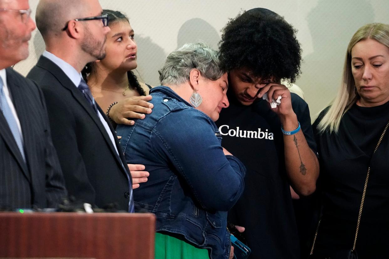 Rebecca Duran (in denim jacket), the mother of Donovan Lewis, is comforted by a family member as body camera footage of the Tuesday shooting of her son by Columbus police is played during a press conference at the Sheraton Capital Square on Thursday.