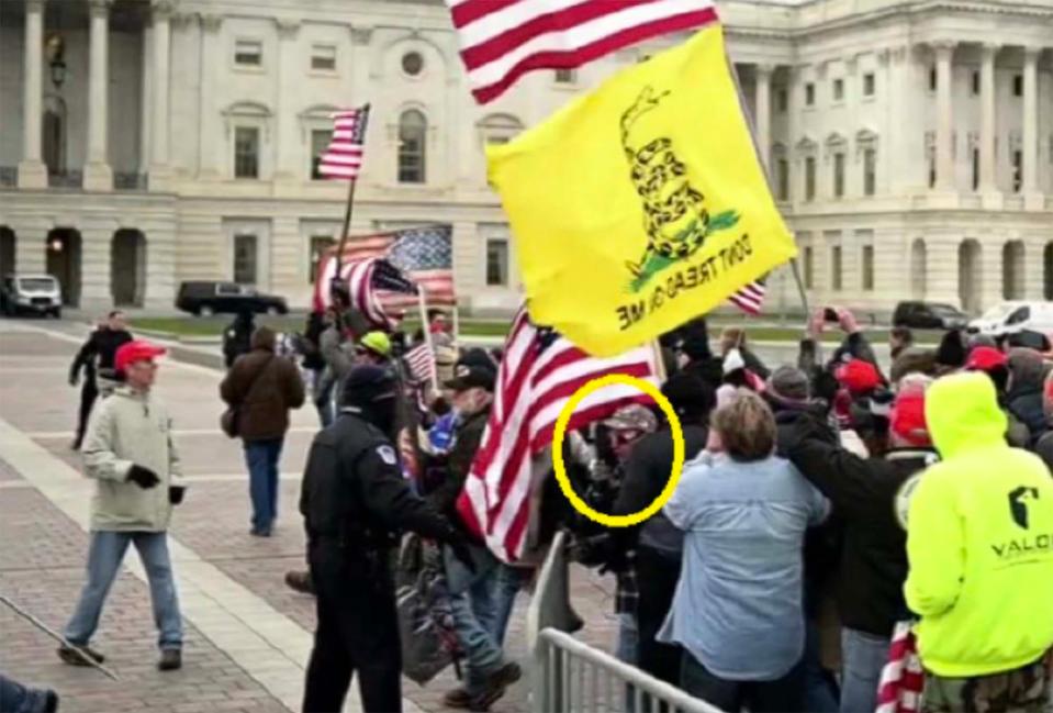 Jeremiah Powell is allegedly pictured here pushing past police barriers to storm towards the Capital building on Jan. 6, 2021.