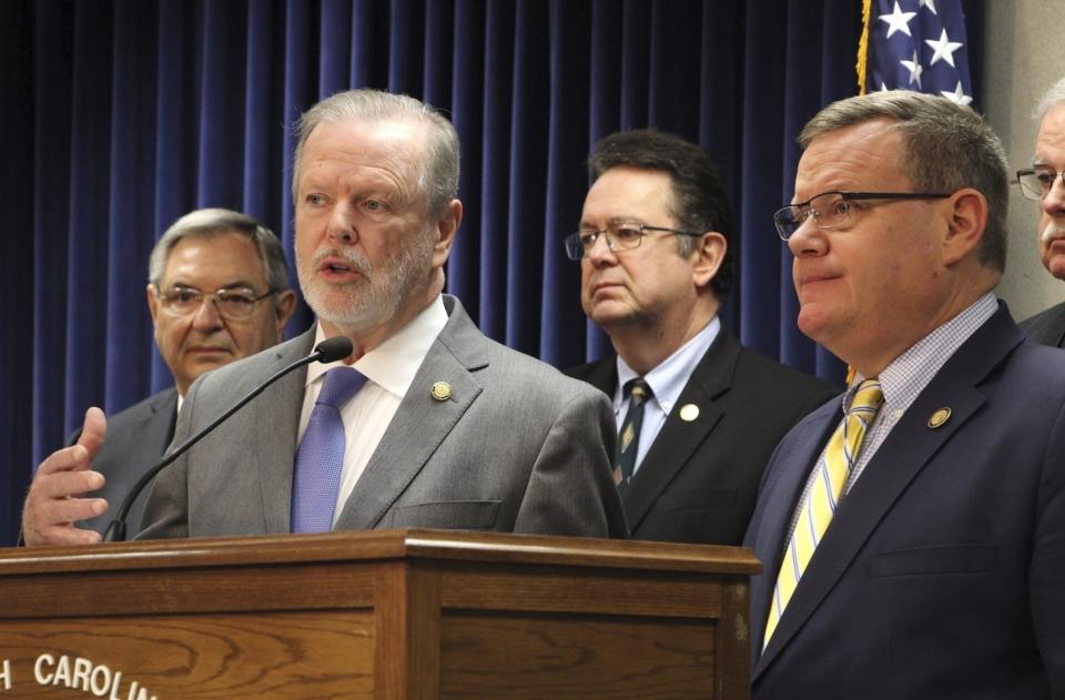 FILE - North Carolina Senate leader Phil Berger, left, speaks alongside House Speaker Tim Moore at a news conference about a Medicaid expansion agreement on March 2, 2023, at the Legislative Building in Raleigh, N.C. The agreement to expand Medicaid in the state neared final legislative approval Wednesday, March 23, 2023, as the House agreed to a bipartisan plan to ease or eliminate regulations that block the opening of new hospital beds or operating expensive equipment. (AP Photo/Hannah Schoenbaum, File)