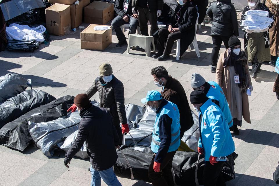 Dead bodies in bags lie on the floor in a cemetery morque (Getty Images)