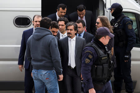 The eight Turkish soldiers, who fled to Greece in a helicopter and requested political asylum after a failed military coup against the government, are escorted by police officers as they arrive at the Supreme Court in Athens, Greece, January 26, 2017. REUTERS/Alkis Konstantinidis