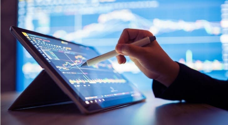 Woman looking at her stocks on a screen