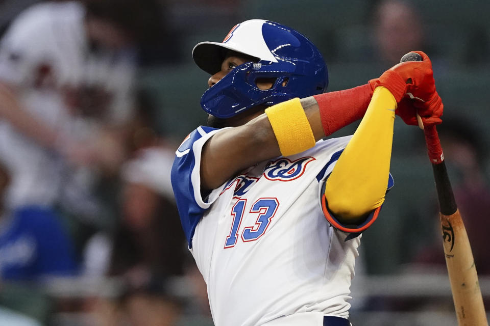 Atlanta Braves' Ronald Acuna Jr. follows through on a solo home run during the fourth inning of the team's baseball game against the Milwaukee Brewers on Friday, May 6, 2022, in Atlanta. (AP Photo/John Bazemore)