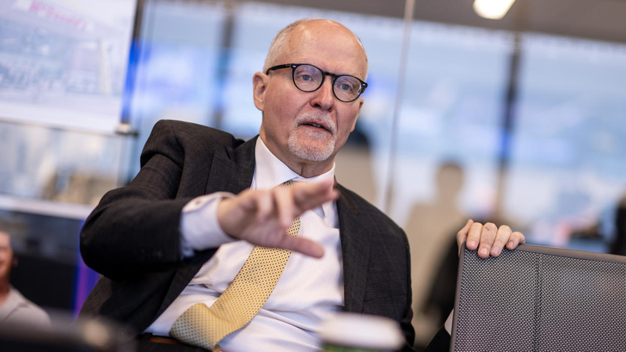 Paul Vallas, in suit and tie, emphasizes his point.