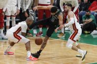 Boston Celtics' Jayson Tatum (0) competes against Miami Heat's Kyle Lowry (7) and Max Strus for the ball during the second half of Game 6 of the NBA basketball playoffs Eastern Conference finals Friday, May 27, 2022, in Boston. (AP Photo/Michael Dwyer)