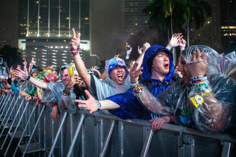 Festival goers react to the rain during a set by Tiesto on Main Stage during Ultra 2024 at Bayfront Park in Downtown Miami on Friday, March 22, 2024.