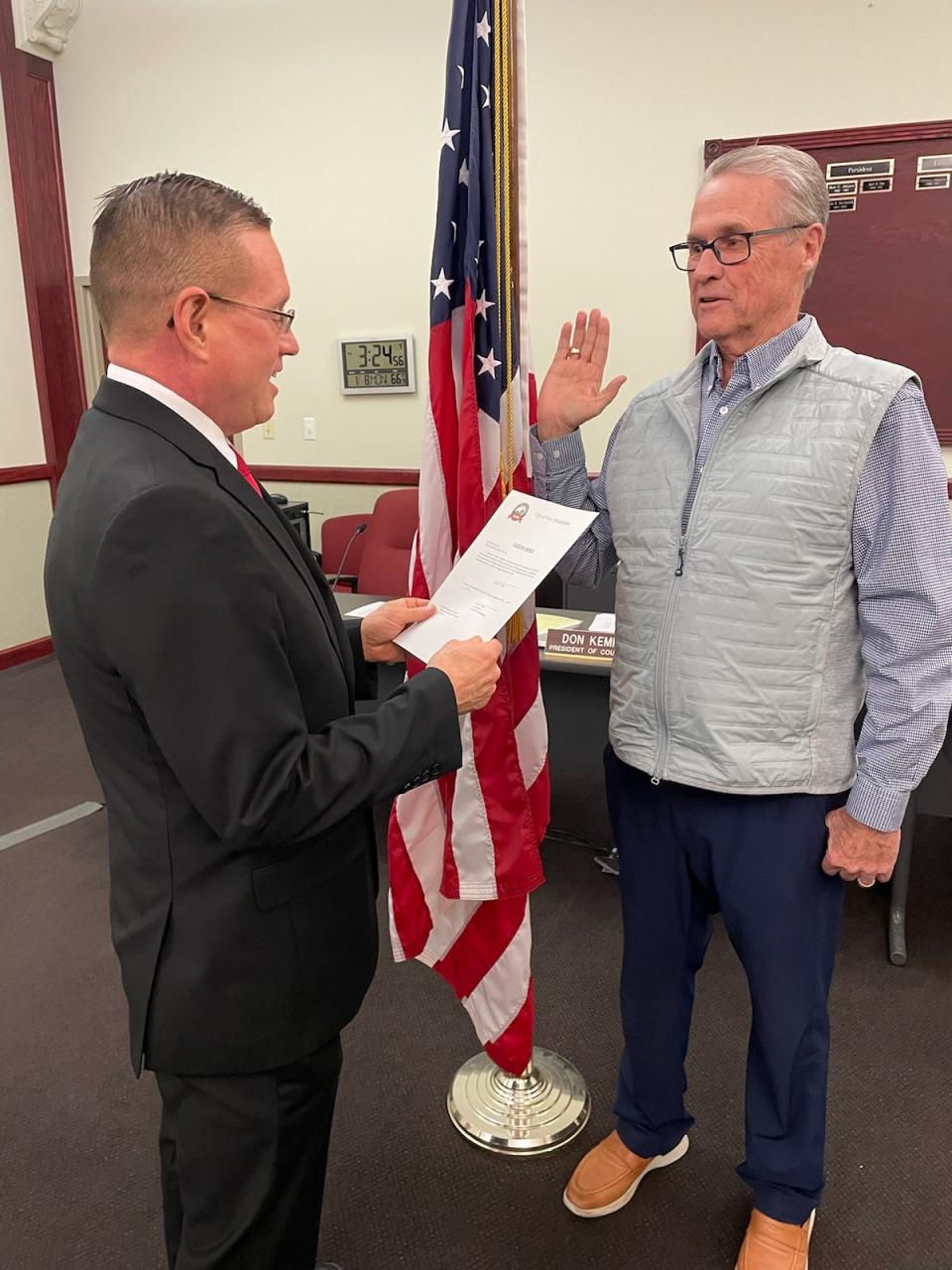 New Philadelphia Council President Don Kemp takes the oath of office Monday from Law Director Marvin Fete.