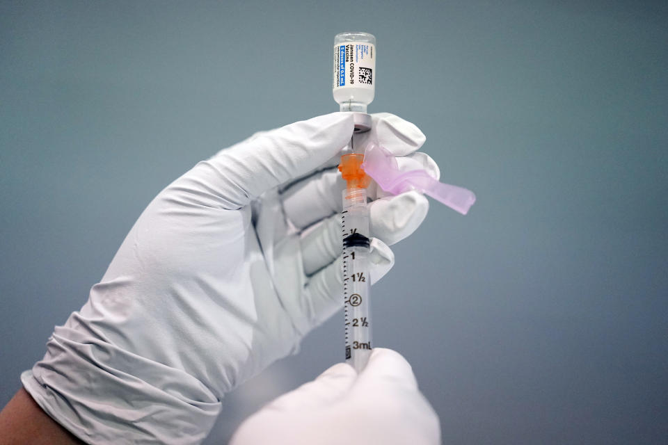 FILE - In this March 26, 2021, file photo a member of the Philadelphia Fire Department prepares a dose of the Johnson & Johnson COVID-19 vaccine at a vaccination site setup in Philadelphia. The vaccination drive is lagging far behind in many Amish communities across the U.S. following a wave of virus outbreaks that swept through their churches and homes during the past year. (AP Photo/Matt Rourke, File)