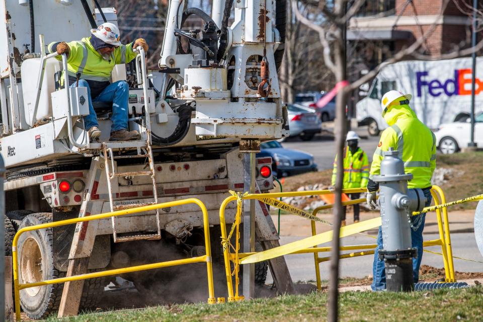 LE Myers Co. workers create new foundations for larger electric poles on Patterson Drive on Tuesday, March 15, 2023, as part of Duke Energy's Bloomington Reliability Project.