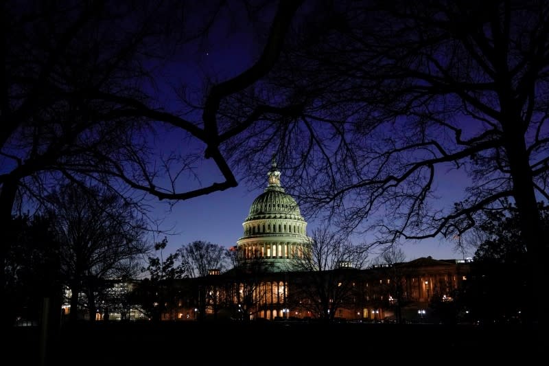 FILE PHOTO: The U.S. Capitol stands as evening falls on the first day of the Trump impeachment trial in Washington.