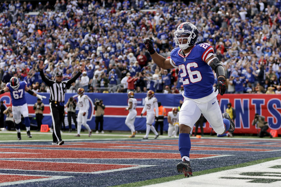 New York Giants running back Saquon Barkley (26) reacts after scoring a touchdown against the Washington Commanders during the second quarter of an NFL football game, Sunday, Oct. 22, 2023, in East Rutherford, N.J. (AP Photo/Adam Hunger)