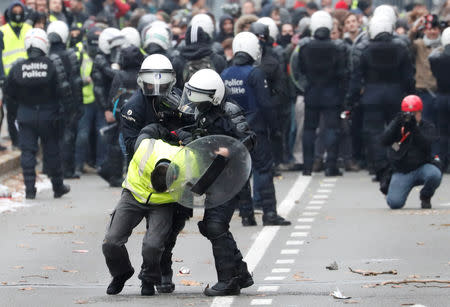 A demonstrator is detained by police during the "yellow vests" protest against higher fuel prices, in Brussels, Belgium, December 8, 2018. REUTERS/Yves Herman