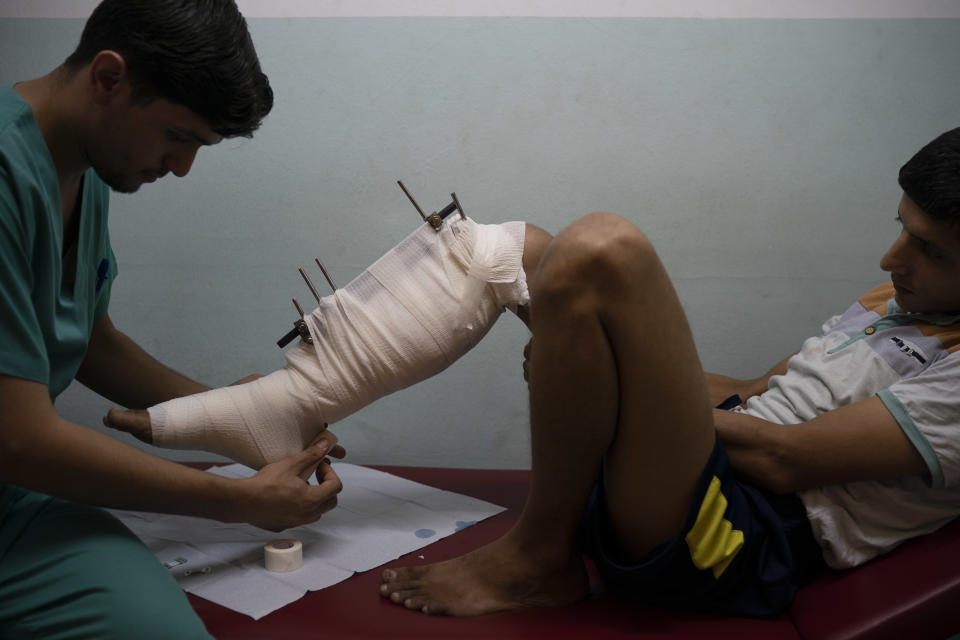 In this Sept. 10, 2018, photo, Mahmoud Abu Assi, who was shot in the leg during a demonstration, has his bandage changed in a clinic run by MSF (Doctors Without Borders) in Gaza City. Ever since Hamas launched demonstrations in March against Israel's blockade of Gaza, children have been a constant presence in the crowds. Since then, U.N. figures show that 948 children under 18 have been shot by Israeli forces and 2,295 have been hospitalized, including 17 who have had a limb amputated. (AP Photo/Felipe Dana)