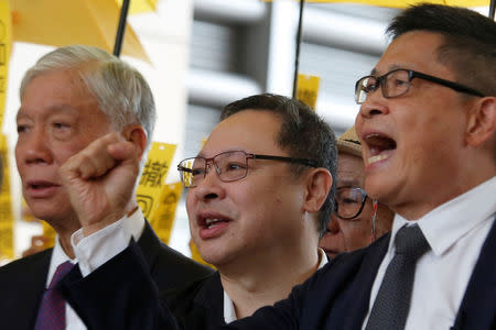 (L-R) Occupy Central pro-democracy movement founders Chu Yiu-ming, Benny Tai and Chan Kin-man chant slogans outside a court in Hong Kong, China November 19, 2018. REUTERS/Bobby Yip