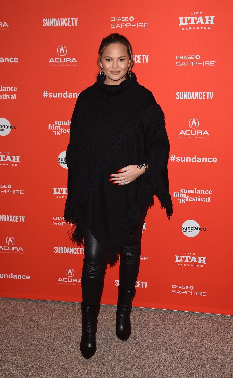 <p>Teigen wears a black-fringe poncho, leather pants, and black boots to the 2018 Sundance Film Festival in Park City, Utah. (Photo: Getty Images) </p>