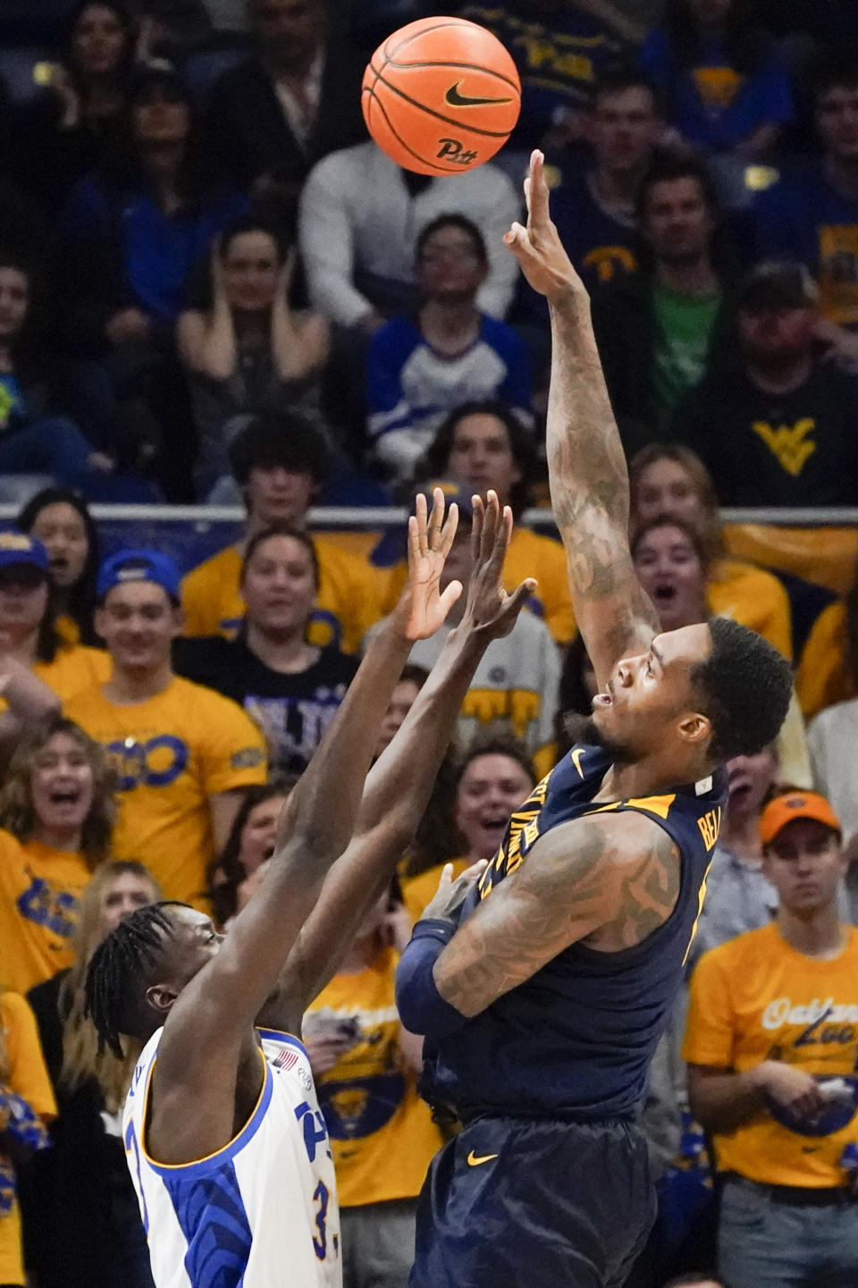 West Virginia's Jimmy Bell Jr., right, shoots over Pittsburgh's Federiko Federiko, left, during the first half of an NCAA college basketball game, Friday, Nov. 11, 2022, in Pittsburgh. (AP Photo/Keith Srakocic)
