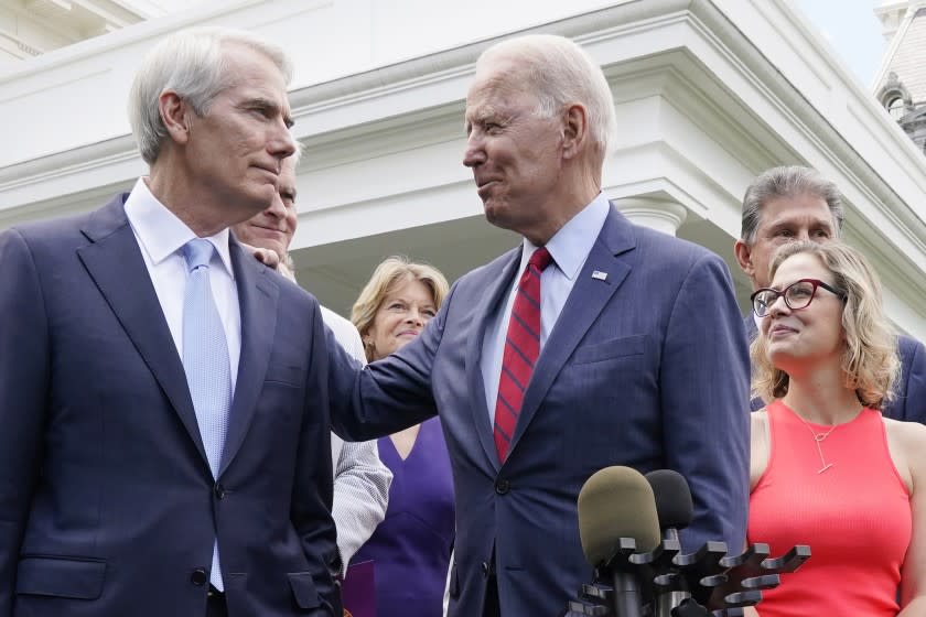 President Joe Biden speaks with Sen. Rob Portman, R-Ohio, and other bipartisan group of senators, Thursday June 24, 2021, outside the White House in Washington. Biden invited members of the group of 21 Republican and Democratic senators to discuss the infrastructure plan. From left are Portman, Sen. Bill Cassidy, R-La., Sen. Lisa Murkowski, R-Alaska, Biden, Sen, Joe Manchin, D-W.Va., rear, and Sen. Kyrsten Sinema. (AP Photo/Jacquelyn Martin)