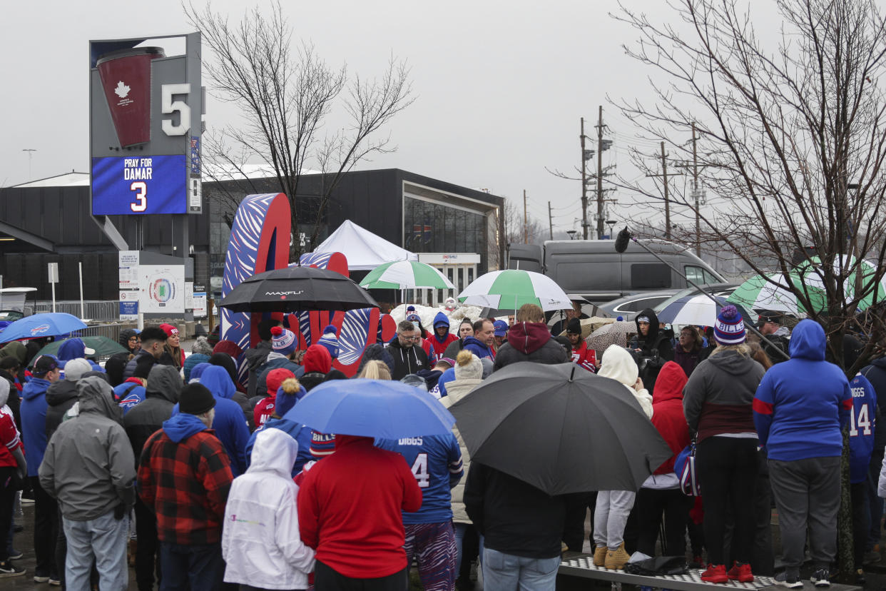 Buffalo Bills fans and community members gather outside Highmark Stadium for a prayer circle for Buffalo Bill' Damar Hamlin on Tuesday, Jan. 3, 2023, in Orchard Park, N.Y. (AP Photo/Joshua Bessex)