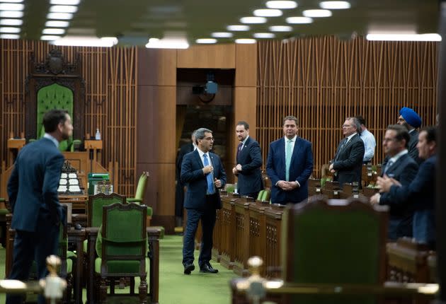 Conservative MPs, including leader Andrew Scheer, wait for the speaker's parade to arrive, as a limited number of MPs return to the house to discuss measures to respond to the COVID-19 outbreak, in Ottawa, on March 24, 2020.