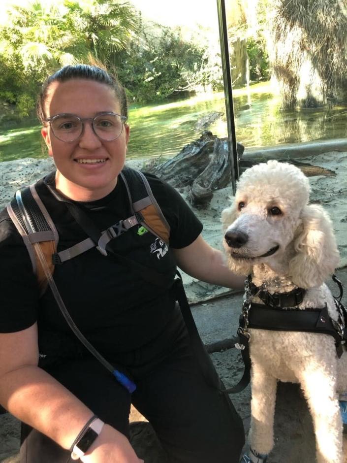 Handler and dog in service dog vest at the zoo