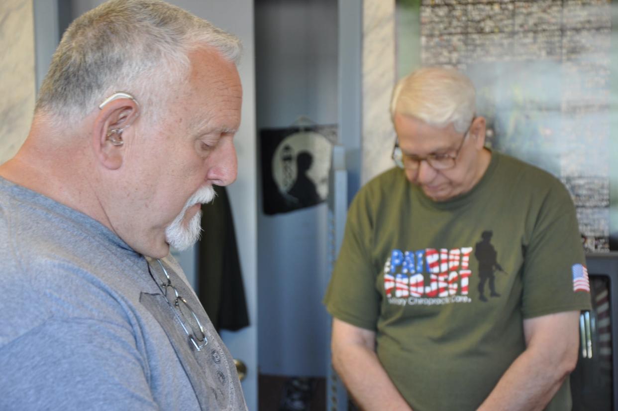 Robert LaMotta (left), a state delegate for the Vietnam Veterans of America Thomas A. Mangino Chapter 157 of Alliance, and Sherman Brick, the chapter's representative on the Stark County Veterans Commission, pray before the chapter's monthly meeting on May 1, 2024.