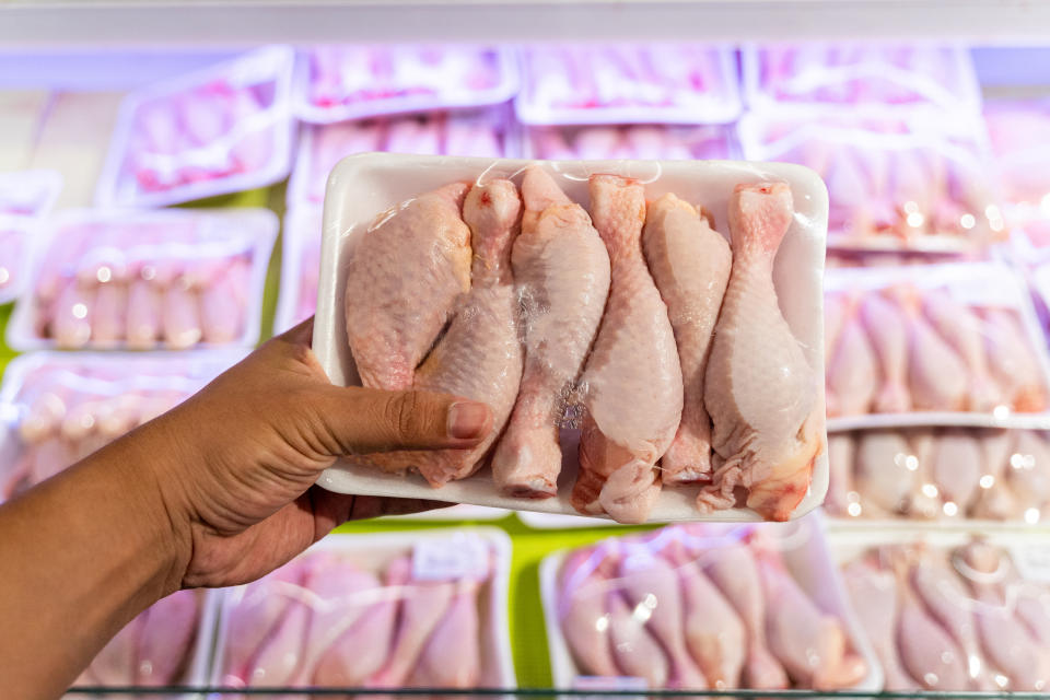 Point of View Hand Holding Chicken in a grocery store