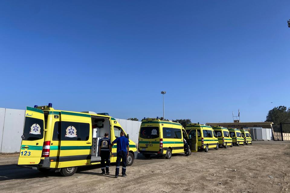 Ambulances line up to cross the Rafah border from the Egyptian side to transport the injured from Gaza on Nov. 6, 2023.