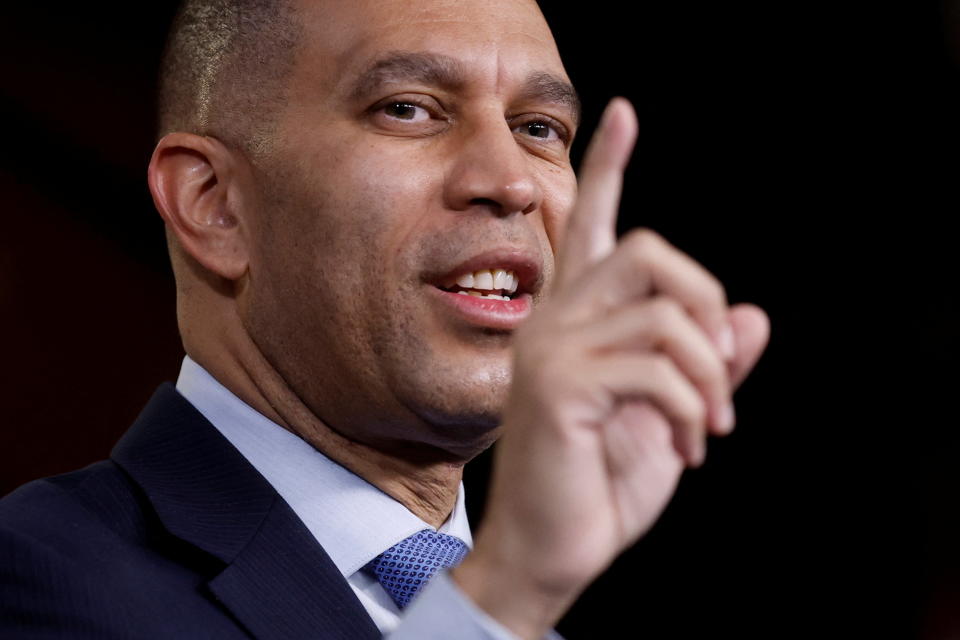 Hakeem Jeffries raises an index finger mid-address.