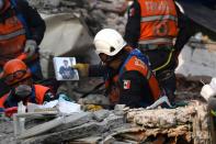 A rescue worker recovers objects and belongings that can help identify quake victims during the search for survivors and bodies in Mexico City