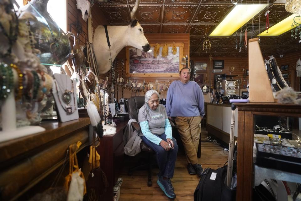 Delaine Spilsbury, an Ely Shoshone elder, and her son Rick Spilsbury look on during an interview at their shop at the Prospector Hotel & Gambling Hall where they sell authentic Native American art on Nov. 10, 2023, in Ely, Nev. (AP Photo/Rick Bowmer)