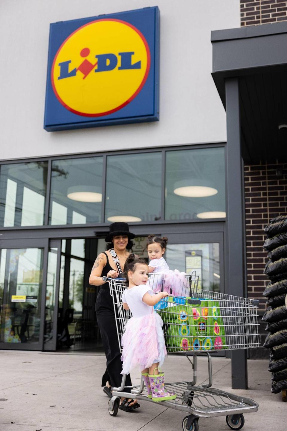 Maria Colgrove pushes her cart with her twin daughters, Mia, 3, left and Penelope, 3, at Lidl in Charlotte, N.C., on Monday, April 3, 2023.