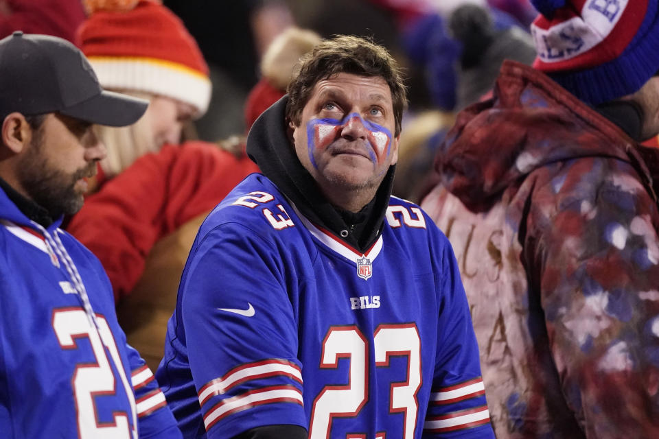 Fans watch from the stands during overtime in an NFL divisional round playoff football game between the Kansas City Chiefs and the Buffalo Bills, Sunday, Jan. 23, 2022, in Kansas City, Mo. The Chiefs won 42-36. (AP Photo/Charlie Riedel)