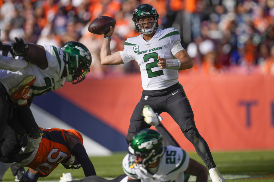 New York Jets quarterback Zach Wilson (2) works in the pocket against the Denver Broncos during the second half of an NFL football game, Sunday, Oct. 23, 2022, in Denver. (AP Photo/David Zalubowski)